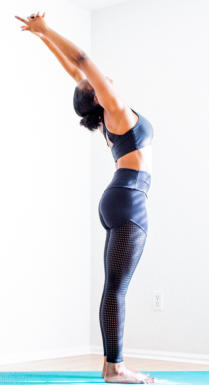 Image of woman standing and stretching her back with hands over her head
