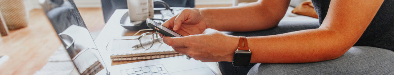Photo of person's hands holding a mobile phone