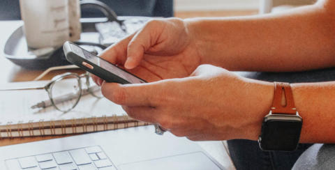 Photo of person's hands holding a mobile phone